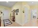 Hallway with beige tile flooring and decorative accents, connecting to other rooms of the home at 17500 Butterfly Pea Ct, Clermont, FL 34714