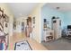 Bright hallway with beige tile flooring connecting to the bedrooms, bathrooms and office space at 17500 Butterfly Pea Ct, Clermont, FL 34714