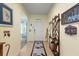 Inviting hallway with decorative accents, beige tile flooring and a view of other rooms at 17500 Butterfly Pea Ct, Clermont, FL 34714