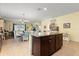 Open-concept kitchen featuring an island, with seamless flow into dining and living areas at 17500 Butterfly Pea Ct, Clermont, FL 34714