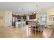 Bright, open kitchen with stainless steel appliances, ample counter space, and adjacent dining area at 17500 Butterfly Pea Ct, Clermont, FL 34714