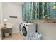 Bright laundry room with new washer and dryer and decorative curtains at 17500 Butterfly Pea Ct, Clermont, FL 34714