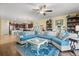 Open-concept living room with a large sectional sofa, seamlessly connected to the kitchen at 17500 Butterfly Pea Ct, Clermont, FL 34714