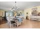 Open living space featuring a dining area with chandelier lighting and views of the living room at 17500 Butterfly Pea Ct, Clermont, FL 34714