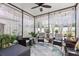 Enclosed patio featuring wicker furniture, decorative plants, and beautiful decor at 17500 Butterfly Pea Ct, Clermont, FL 34714