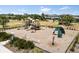 A colorful playground with slides and climbing structures surrounded by green grass at 17500 Butterfly Pea Ct, Clermont, FL 34714