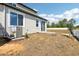 Backyard featuring a patio area, landscaping, and sliding glass doors to the home at 1805 Archer Dr, Minneola, FL 34715
