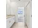 This is a bathroom with double sinks, a granite countertop, and tiled floors at 1805 Archer Dr, Minneola, FL 34715