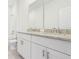 Bathroom features double sink with granite countertop and tiled floor at 1805 Archer Dr, Minneola, FL 34715