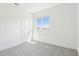 Bright bedroom features neutral carpet, large window, and fresh white walls at 1805 Archer Dr, Minneola, FL 34715