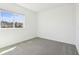 Bright bedroom features neutral carpet, a large window, and fresh white walls at 1805 Archer Dr, Minneola, FL 34715