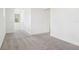 Upstairs hallway with neutral carpet and white walls at 1805 Archer Dr, Minneola, FL 34715
