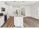 Bright kitchen features white cabinets, stainless steel appliances, and a large center island with sink at 1805 Archer Dr, Minneola, FL 34715