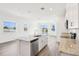 Bright kitchen with center island, stainless steel appliances, and open view to living area with bright, natural light at 1805 Archer Dr, Minneola, FL 34715