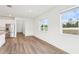 Bright, open-concept kitchen featuring stainless steel appliances and white cabinets with an adjacent dining area at 1805 Archer Dr, Minneola, FL 34715