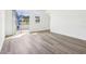 Bright and airy living room boasts wood-look floors and a sliding glass door for seamless indoor-outdoor living at 1805 Archer Dr, Minneola, FL 34715