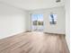 Bright and airy living room with wood-look floors, sliding glass door, and expansive windows at 1805 Archer Dr, Minneola, FL 34715