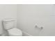 A traditional toilet in a bathroom with a window at 1805 Archer Dr, Minneola, FL 34715