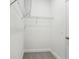Walk-in closet with installed metal shelving and neutral carpet at 1805 Archer Dr, Minneola, FL 34715
