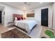 Bright bedroom with hardwood floors, neutral walls, king bed with a pink headboard, and modern decor at 200 Carolina Ave # 201, Winter Park, FL 32789