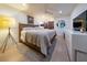 Bedroom featuring hardwood floors, neutral walls, king bed, modern dresser, and decorative elements at 200 Carolina Ave # 201, Winter Park, FL 32789