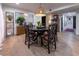 Dining room with round table, distinctive chairs, decor, shelving, art and wood floors at 200 Carolina Ave # 201, Winter Park, FL 32789