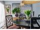 Close-up dining room featuring black chairs, bronze bust planter, and wooden floors at 200 Carolina Ave # 201, Winter Park, FL 32789