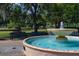 Picturesque park fountain with turquoise water, surrounded by lush greenery and benches for relaxation at 200 Carolina Ave # 201, Winter Park, FL 32789