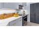 Bright modern kitchen with white cabinets, stainless steel appliances, and decorative elements at 200 Carolina Ave # 201, Winter Park, FL 32789