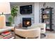 Cozy living room featuring fireplace, bookshelves, plush seating, and wood floors at 200 Carolina Ave # 201, Winter Park, FL 32789
