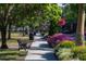 Scenic tree-lined street with colorful flower beds and a sidewalk, perfect for a leisurely stroll at 200 Carolina Ave # 201, Winter Park, FL 32789