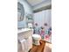 Charming bathroom featuring a white vanity, floral shower curtain, and wood look tile at 200 W 27Th St, Sanford, FL 32773