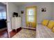 Cozy bedroom with sunny yellow decor, decorative pillows, and dresser with mounted television at 200 W 27Th St, Sanford, FL 32773