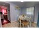 Cozy dining area with a wooden table, white chairs, and adjacent view to a bedroom at 200 W 27Th St, Sanford, FL 32773