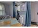 Functional dining area with laundry appliances, a light wood table and white chairs at 200 W 27Th St, Sanford, FL 32773