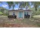 Charming single-story home featuring a vibrant blue door and well-maintained landscaping at 200 W 27Th St, Sanford, FL 32773