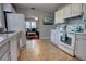 Bright kitchen with white cabinetry, tile flooring, and view of the living room at 200 W 27Th St, Sanford, FL 32773