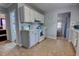Functional kitchen with white appliances, tile flooring, and easy access to other rooms at 200 W 27Th St, Sanford, FL 32773