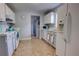 Well-lit kitchen with white appliances, tile flooring, and blue accents at 200 W 27Th St, Sanford, FL 32773