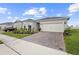 Well maintained home boasts a brick paver driveway and manicured landscaping at 2003 Spring Shower Cir, Kissimmee, FL 34744