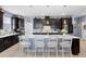 Elegant kitchen featuring a central island with seating and ample dark-wood cabinetry at 2003 Spring Shower Cir, Kissimmee, FL 34744