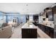 Open-concept kitchen with large island, stainless appliances, and modern countertops at 2003 Spring Shower Cir, Kissimmee, FL 34744