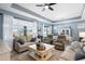Spacious living room with a view of the dining area, featuring comfortable seating and natural light at 2003 Spring Shower Cir, Kissimmee, FL 34744