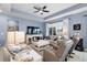 Comfortable living room with plush seating, ceiling fan, and a decorative fireplace feature at 2003 Spring Shower Cir, Kissimmee, FL 34744