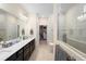 Elegant main bathroom with double vanity, tiled shower, and access to walk-in closet at 2003 Spring Shower Cir, Kissimmee, FL 34744