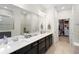 Spacious main bathroom featuring double sinks, large mirror, and access to a walk-in closet at 2003 Spring Shower Cir, Kissimmee, FL 34744