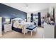 Comfortable main bedroom with king bed, desk and dark blue accent wall at 2003 Spring Shower Cir, Kissimmee, FL 34744