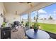 Screened patio with outdoor seating, grill and backyard view at 2003 Spring Shower Cir, Kissimmee, FL 34744