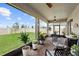 Spacious screened patio showcasing a paver floor, ceiling fans and tranquil backyard views at 2003 Spring Shower Cir, Kissimmee, FL 34744