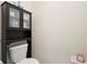 Toilet with overhead cabinet and shelf providing storage at 2003 Spring Shower Cir, Kissimmee, FL 34744
